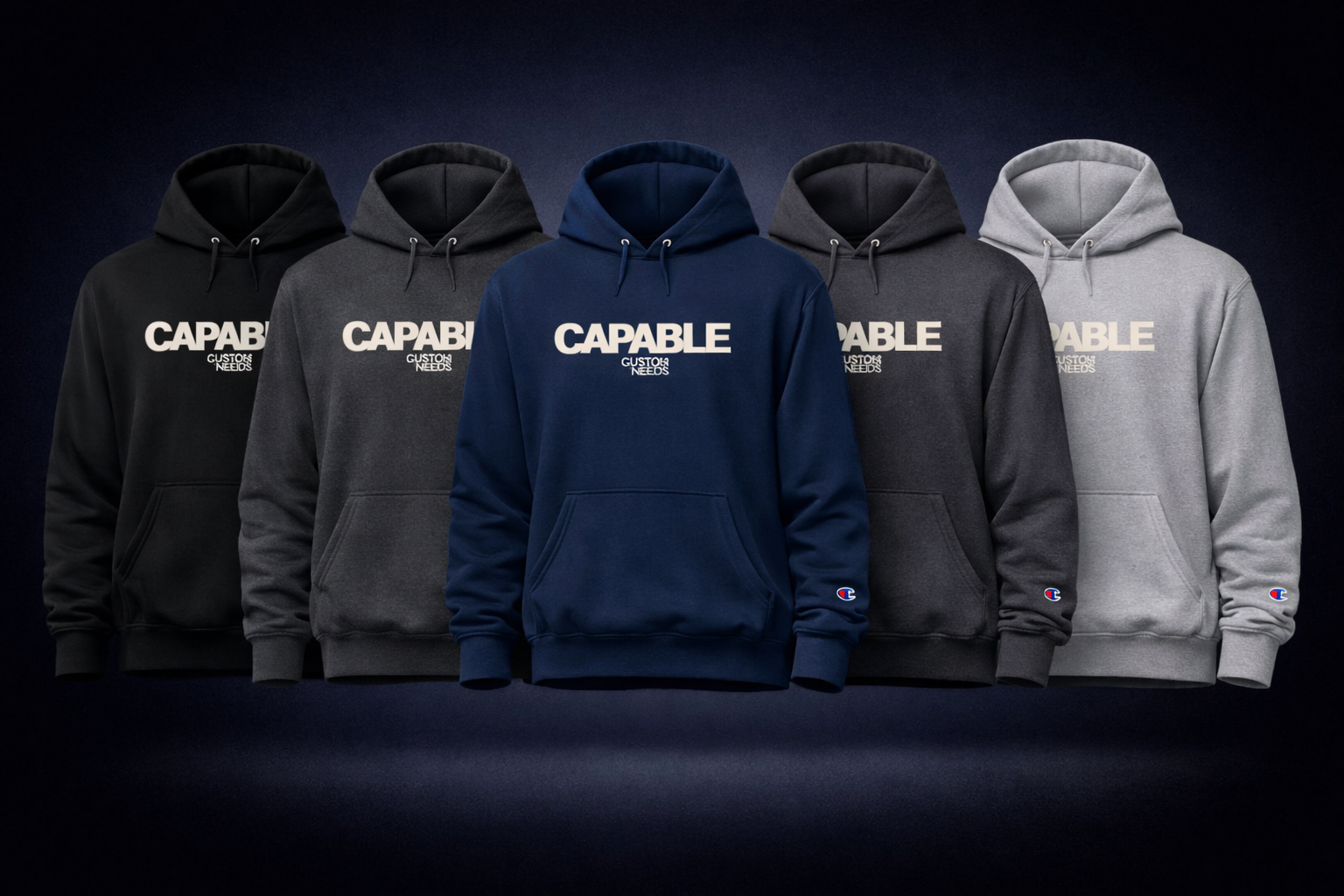 Five hoodies in black, gray, blue, and gray with 'CAPABLE' branding on a dark background.