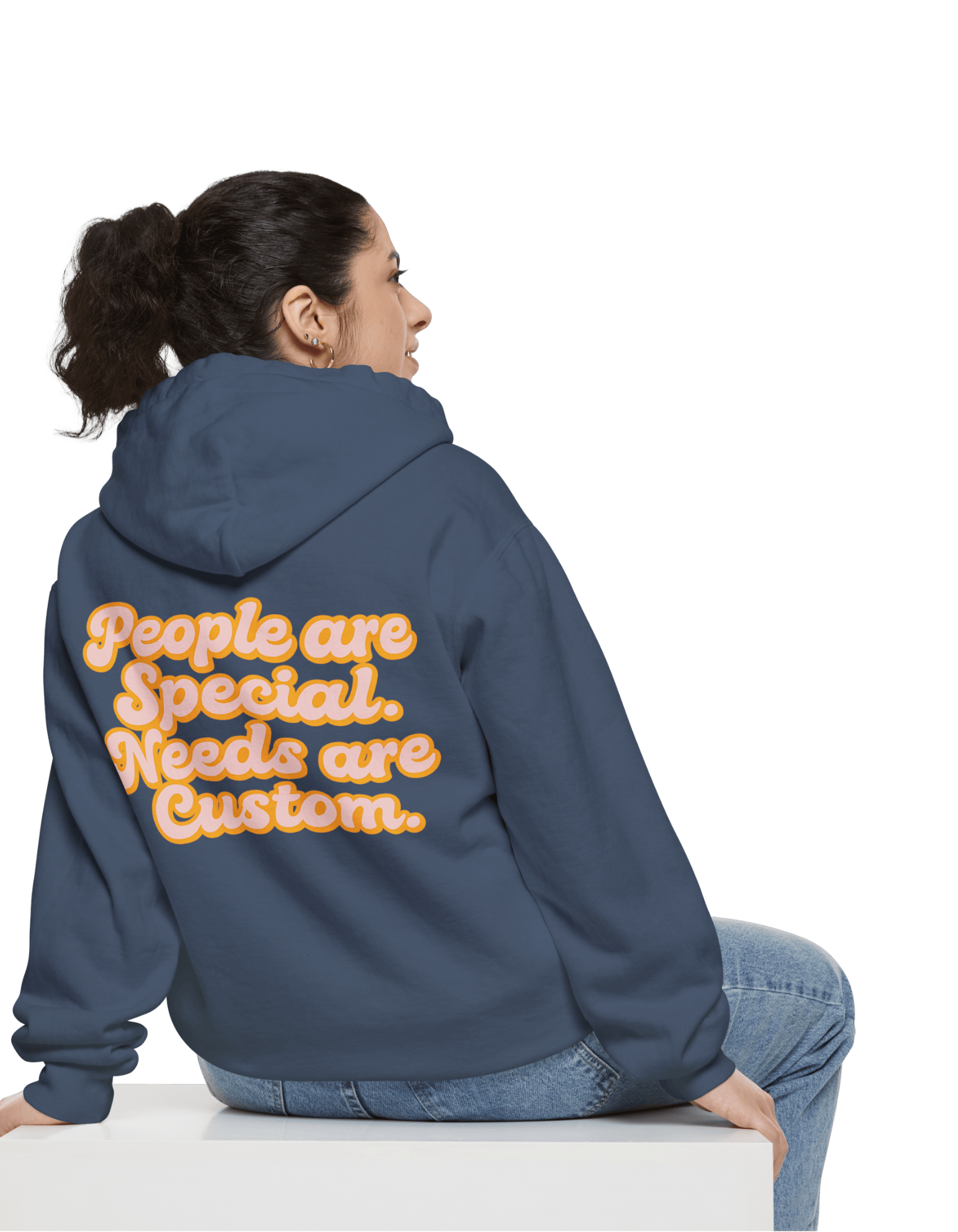 Person wearing a blue hoodie with a motivational quote on the back, sitting on a white surface.